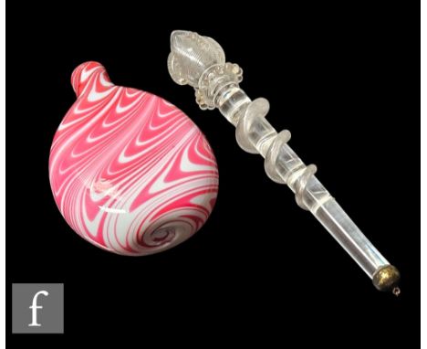 A late 19th Century Nailsea flask of compressed ovoid form with collar neck, decorated with pulled ruby trailed loop over an 