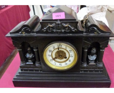 A French mantle clock in slate architectural case, the 8 day brass drum movement striking on a coiled gong. 12½'' high
