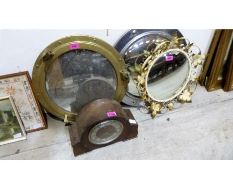 A brass porthole with mirror plate, two metal framed convex mirrors and a mantle clock