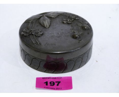 An Art Nouveau pewter powder box stamped ETAIN ARTISTIQUE, the cover repousse decorated with foliage and signed Pechez. Frenc