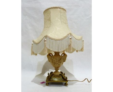 A 1920's gilt brass and composition table lamp in the form of an urn with rams head and vine fruit decoration on heavy decora