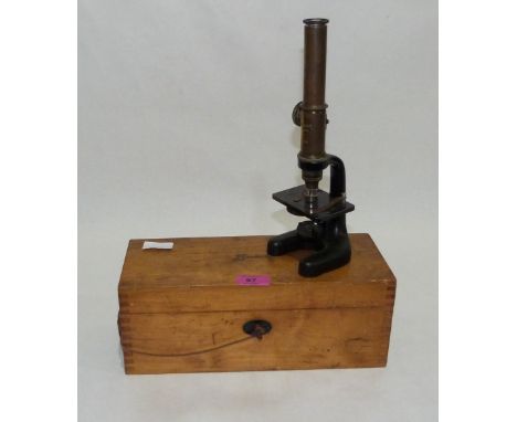 A Busch brass and iron monocular microscope with ratchet focus. Boxed.
