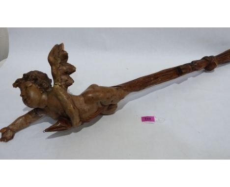 Catholic Art: A carved limewood cherubic lamp holder, the handle carved as a tasselled knotted ribbon. 19th century or earlie