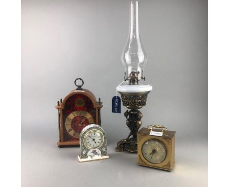 REPRODUCTION CAST BRASS OIL LAMP, with opaque glass reservoir and three small mantel clocks (4)