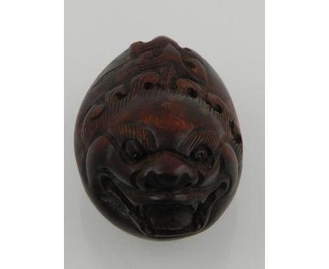 A wooden netsuke in the form of a dragon. L.5cm 