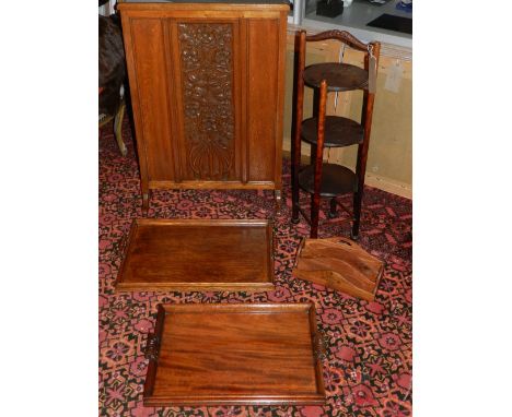 A three tier oak cake stand, together with a carved oak firescreen, two trays, and a letter rack. 