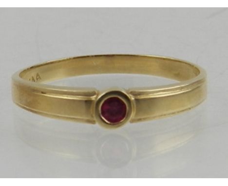 A 10 carat yellow gold and ruby ring. 