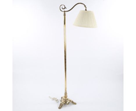 A brass standard lamp, late 19th/early 20th century, on heavy cast tricorn-shaped base, modern fabric shade, overall height 1