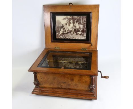 A 19th century table symphonion, floral marquetry inlaid case with brass mounts, transfer printed panel inside lid playing 30