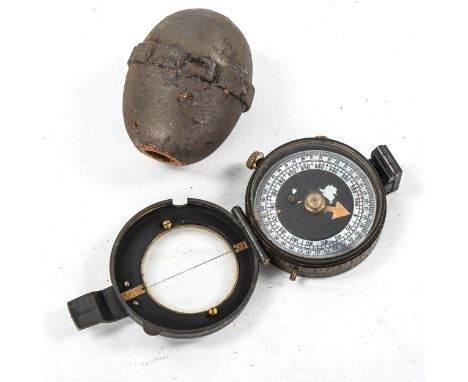 A Great War German egg grenade, circa 1917 (inactive), length 5.5cm, and a military trench compass (undated) (2) 