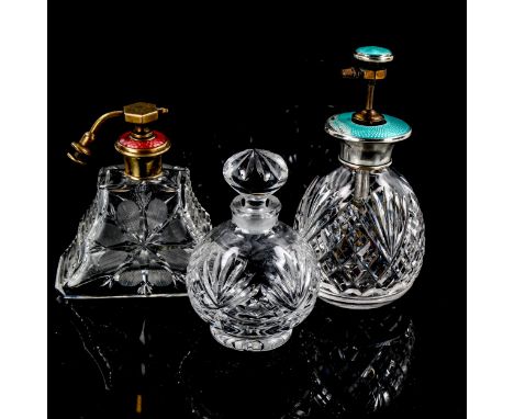 A silver and turquoise enamel cut-glass atomiser perfume bottle, a brass and enamel-topped atomiser perfume bottle, and a cut