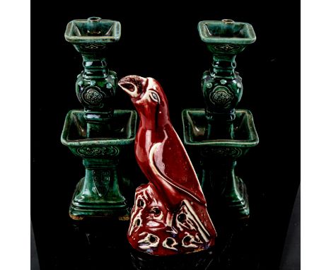 A pair of Chinese green glazed ceramic candle stands, height 25cm, and a sang de boeuf glaze parrot, height 22cm (3) 