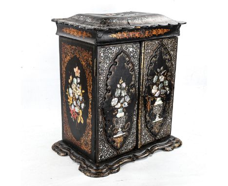 A Victorian papier mache table cabinet, mother-of-pearl inlaid and gilded, with 2 doors enclosing small drawers with central 