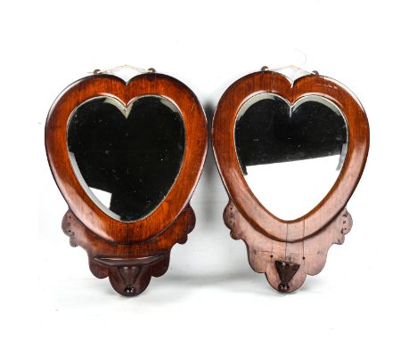 A pair of Victorian mahogany-framed heart-shaped wall mirrors, height 55cm, 1 missing shelf bracket 