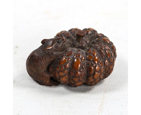 Finely carved Japanese wood netsuke, in the form of a rat with a pumpkin, Meiji Period, length 4cm 
