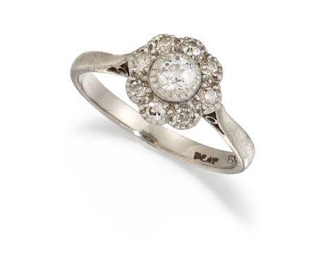 AN 18 CARAT GOLD AND PLATINUM DIAMOND CLUSTER RING, the central old cut diamond surrounded by smaller single cut diamonds, to