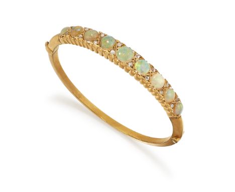 AN OPAL AND DIAMOND BANGLE, the graduated round opal cabochons, set with diamond highlights, claw mounted with a scalloped si