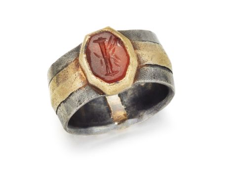 A FRENCH INTAGLIO RING, the oval carnelian intaglio, carved with the initial 'I', in rubover setting of yellow metal, set to 