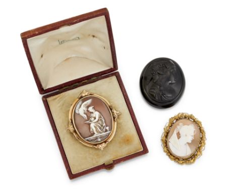 TWO CAMEO BROOCHES AND A JET CAMEO, the first an oval shell cameo of Leda and the swan, collet mounted with scrolled decorati