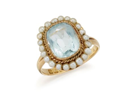 AN 18 CARAT GOLD AQUAMARINE AND SEED PEARL RING, the modified cushion cut aquamarine, collet mounted with rope twist border a