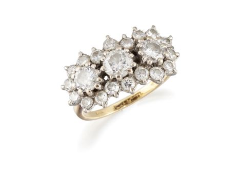 AN 18CT GOLD DIAMOND CLUSTER RING, three round brilliant cut diamonds within a border of smaller round brilliant cut diamonds