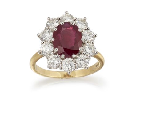 AN 18CT RUBY AND DIAMOND CLUSTER RING, the oval ruby, approx. 10.4 x 8.2 x 4.4mm, surrounded by round brilliant cut diamonds,