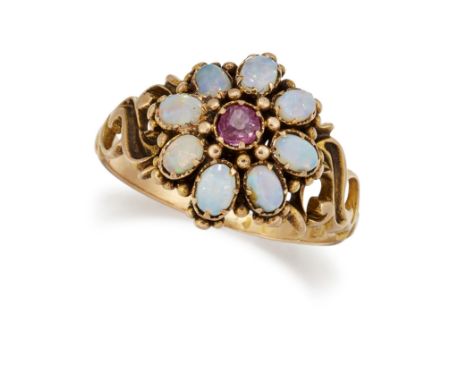 A VICTORIAN 15 CARAT GOLD OPAL AND RUBY CLUSTER RING, the central faceted ruby surrounded by small oval opal cabochons, with 