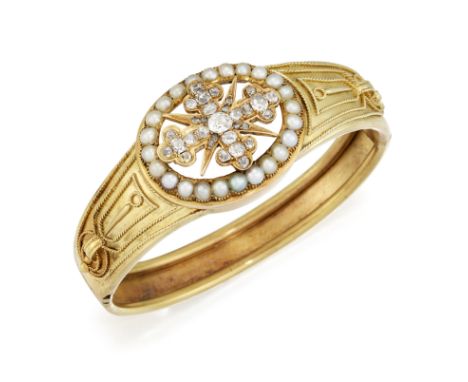 A VICTORIAN DIAMOND AND PEARL BANGLE, the central diamond cross set with old cut diamonds, with a four pointed star with diam