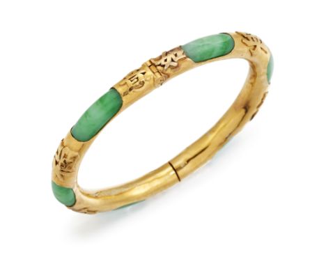 A CHINESE JADE BANGLE, the round jade bangle, approx. 7mm diameter, hinged and mounted in yellow metal with Chinese character