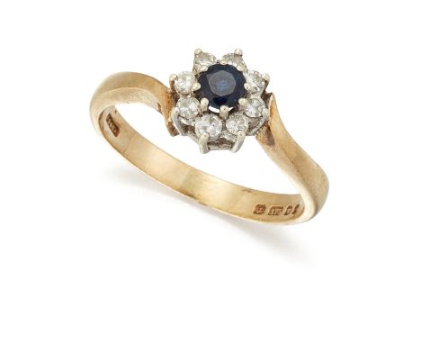 A 9 CARAT GOLD SAPPHIRE AND DIAMOND CLUSTER RING, the round sapphire surround by small, round, brilliant cut diamonds, all se