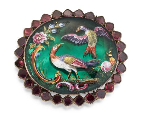 A 19TH CENTURY POLYCHROME ENAMEL AND GARNET CLASP, the oval green ground panel polychrome enamelled with two tropical birds a