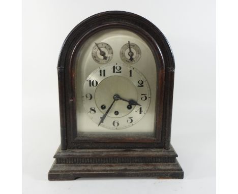 A mahogany cased mantel clock, with an arched top and silvered dial, 36cm high