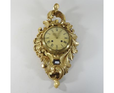 A continental carved giltwood wall clock, 60cm high