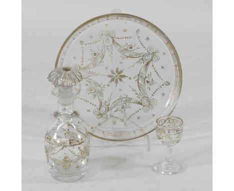 A 19th century glass miniature part decanter set, with gilt decoration, on a tray, 17cm diameter