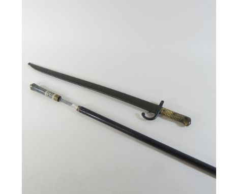 A 19th century bayonet, with scabbard, numbered 28362, 71cm long, together with an antique sword stick