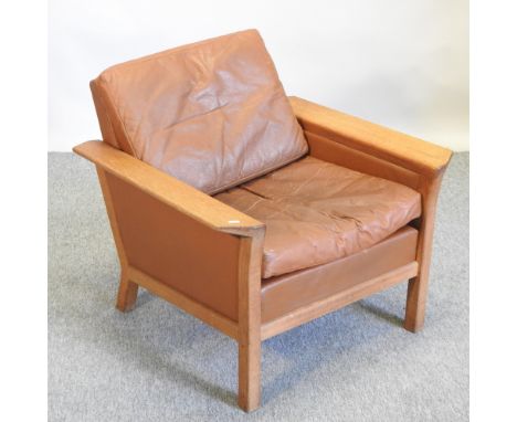 A 1960's Danish light oak and brown leather upholstered armchair