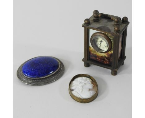 A miniature carriage clock, 6cm high, together with two brooches