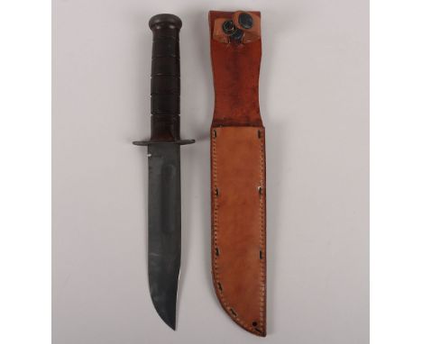 WW2 US KA-BAR Fighting Knife, stamped to the blade ‘KA-BAR’. Mint un-issued condition. With the original stapled and stitched