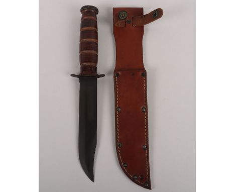 USMC KA-BAR Fighting Knife, housed in leather scabbard. Blade remains in very good overall condition measuring 18cms, overall