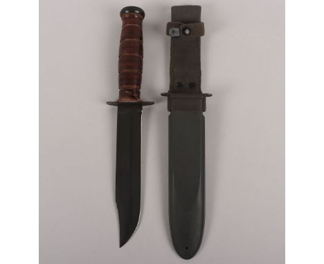 WW2 USN Mk2 KA-BAR, cross guard marked example. Housed in the original scabbard. Generally good example. Blade 17 ½ cms, over