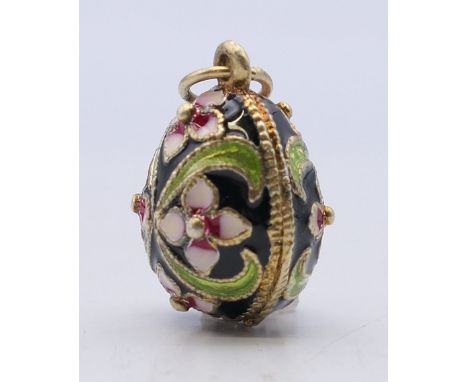 A silver enamel egg pendant. 2.5 cm high. 