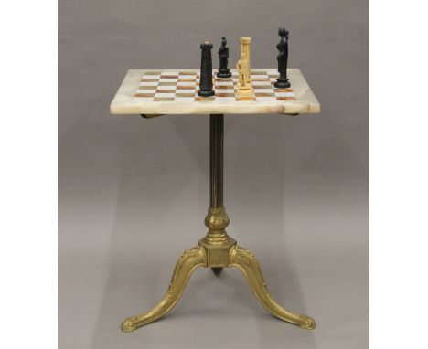 An onyx and brass chess table and a resin chess set. 46 cm square.