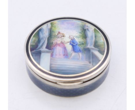 A late 19th/early 20th century French silver and enamel pill box, the lid decorated with a courting couple. 3.75 cm diameter.