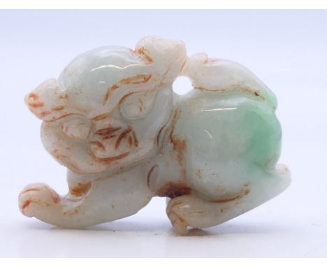 A small jade dog-of-fo. 4 cm long.