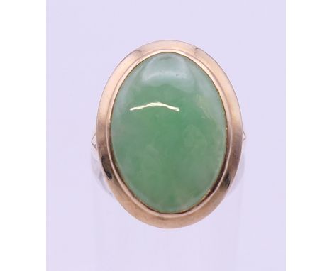 A 14 ct gold jade ring. Ring size N.