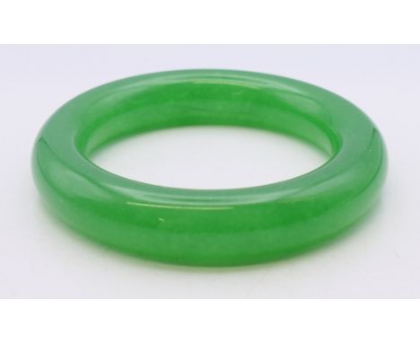 An apple green bangle. Approximately 5.5 cm internal diameter. 