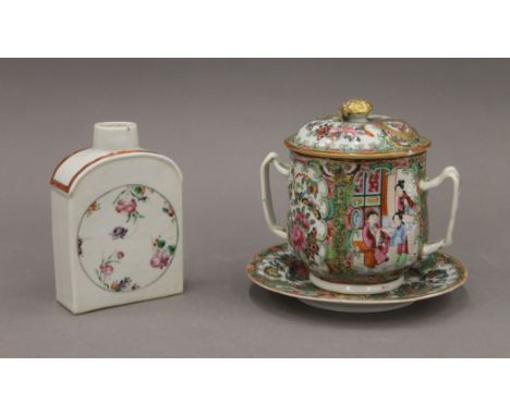 An 18th century Chinese famille rose porcelain tea caddy and a 19th century Canton porcelain twin handled cup, cover and unde