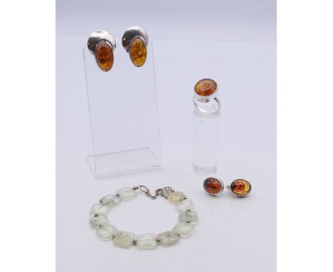A silver and amber ring, two pairs of earrings and a jade bracelet. The latter 16 cm long.
