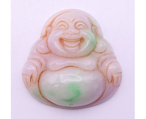 A jade pendant formed as Buddha. 5 cm high. 
