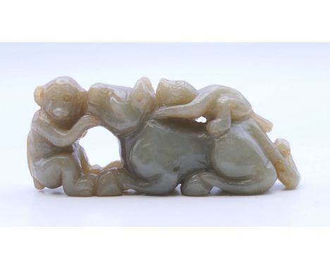 A jade carving of a lion and two monkeys. 8.5 cm long.